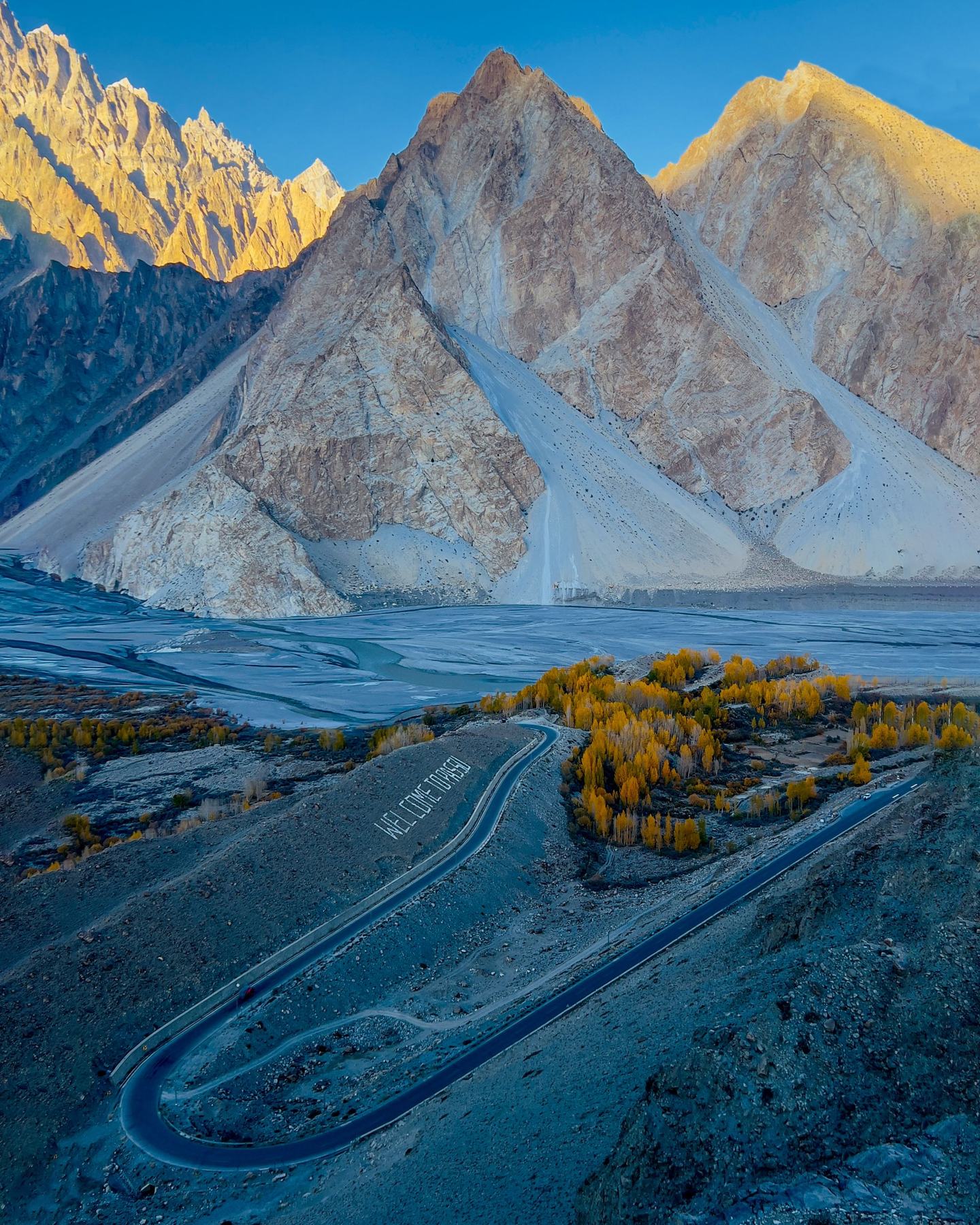 The Karakoram Highway winding below the Passu Cones in autumn